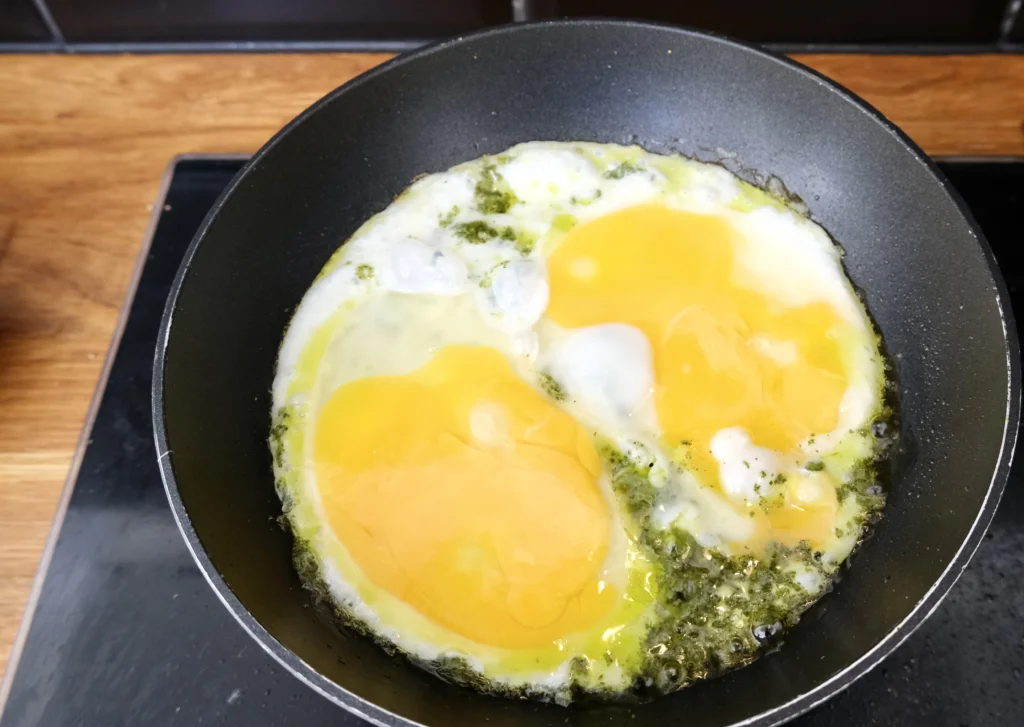 Pesto eggs in pan